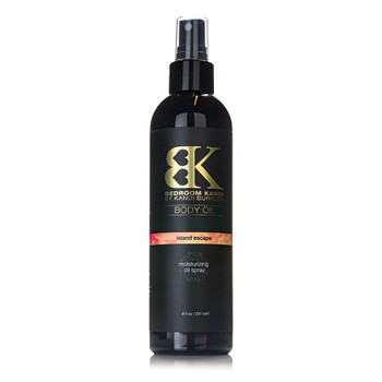A black round-topped bottle of Bedroom Kandi's moisturizing body oil spray in Island Escape fragrance. The bottle has a black pump-spray cap.